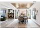 Formal dining room features an elegant light fixture, modern fireplace, and views of the outdoors at 1017 Dillon Lake Dr, Knightdale, NC 27545