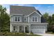 Charming two-story home featuring a covered front porch and an attached two-car garage at 1017 Dillon Lake Dr, Knightdale, NC 27545