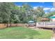 Spacious backyard with a patio, deck, privacy fence, and mature trees providing shade at 102 Lake Meadow Dr, Apex, NC 27502