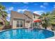 A sparkling backyard above ground pool is framed by a cozy deck and lush tropical landscaping at 102 Lake Meadow Dr, Apex, NC 27502