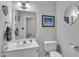 Well-lit bathroom features a decorative mirror and framed beach-themed art at 102 Lake Meadow Dr, Apex, NC 27502