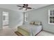 Bright bedroom features neutral walls, ceiling fan, and windows for natural light at 102 Lake Meadow Dr, Apex, NC 27502