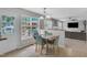 Dining area with aqua chairs and views of the backyard and adjacent living room at 102 Lake Meadow Dr, Apex, NC 27502