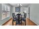 Formal dining room with hardwood floors, large window, and elegant chandelier over a wooden table at 102 Lake Meadow Dr, Apex, NC 27502