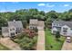 Charming two-story home with a long driveway, manicured lawn, and vibrant pink flowers at 102 Lake Meadow Dr, Apex, NC 27502