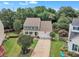 Well-maintained home with a spacious front yard, mature trees, and a two-car garage at 102 Lake Meadow Dr, Apex, NC 27502