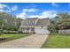 Traditional two-story home with a covered front porch, attached garage, and mature landscaping at 102 Lake Meadow Dr, Apex, NC 27502