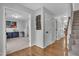 Entryway with hardwood floors, staircase, and view into an office with carpet and neutral paint at 102 Lake Meadow Dr, Apex, NC 27502