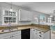 Bright kitchen with granite countertops, white cabinets, and access to the dining area at 102 Lake Meadow Dr, Apex, NC 27502