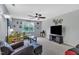 Cozy living room with a ceiling fan, a large TV, and nautical-themed decorations at 102 Lake Meadow Dr, Apex, NC 27502