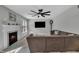 Bright living room with a fireplace, a large sectional couch, and a ceiling fan at 102 Lake Meadow Dr, Apex, NC 27502