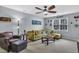 Comfortable living room with a ceiling fan, a green sectional couch, and coastal decorations at 102 Lake Meadow Dr, Apex, NC 27502