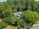 Aerial shot of the home nestled in a lush, tree-filled landscape, highlighting its privacy at 103 Burham Ct, Apex, NC 27502