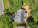 Aerial view of a house with a backyard featuring mature trees and lush landscaping at 103 Burham Ct, Apex, NC 27502