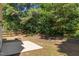 Private backyard featuring a mix of green trees and some hardscape at 103 Burham Ct, Apex, NC 27502