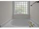 Bathroom with decorative window above soaking tub at 103 Burham Ct, Apex, NC 27502