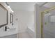 Bathroom boasts double vanity with framed mirrors, tiled floors and glass enclosed shower at 103 Burham Ct, Apex, NC 27502