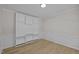 Neutral bedroom has custom-built wall shelving and paneled accent at 103 Burham Ct, Apex, NC 27502