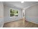 Bedroom with wainscotting and bright natural light from large window at 103 Burham Ct, Apex, NC 27502