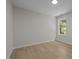 This bedroom features warm floors, a large window, and neutral walls at 103 Burham Ct, Apex, NC 27502