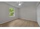 Bedroom features a ceiling fan, neutral paint, updated flooring and a closet at 103 Burham Ct, Apex, NC 27502