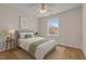 Cozy bedroom with natural light, ceiling fan, and hardwood floors at 103 Burham Ct, Apex, NC 27502