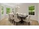 Elegant dining room features a dark wood table, seating for eight, and bright windows at 103 Burham Ct, Apex, NC 27502