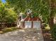 Traditional brick home showcasing a two-car garage, black shutters, and an extended driveway at 103 Burham Ct, Apex, NC 27502