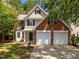 Charming two-story home features a two-car garage, brick accents, and a well-manicured lawn at 103 Burham Ct, Apex, NC 27502
