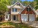 Charming two-story home features a two-car garage, brick accents, and a well-manicured lawn at 103 Burham Ct, Apex, NC 27502