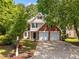 Lovely two-story brick home featuring an attached two-car garage and inviting front yard at 103 Burham Ct, Apex, NC 27502