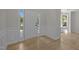 Elegant foyer featuring wood floors, white wainscoting and natural light from the front door at 103 Burham Ct, Apex, NC 27502