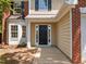 Inviting front entrance with a black door, white trim, and classic architectural details at 103 Burham Ct, Apex, NC 27502
