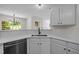Well-lit kitchen with quartz countertops and stainless dishwasher at 103 Burham Ct, Apex, NC 27502