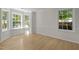 Bright living room with large windows, hardwood floors, and classic wainscoting at 103 Burham Ct, Apex, NC 27502