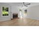 Sunny living room featuring brick fireplace and natural light at 103 Burham Ct, Apex, NC 27502