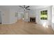 Living room with a brick fireplace and large windows for natural light at 103 Burham Ct, Apex, NC 27502