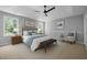 Spacious primary bedroom features a tray ceiling, ceiling fan, and windows with natural light at 103 Burham Ct, Apex, NC 27502