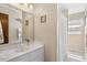 Bathroom featuring a vanity with a white countertop and a framed mirror with walk in shower at 1035 Aquilla Rd, Benson, NC 27524