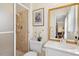 Well-lit bathroom featuring a tiled shower and a sink with an ornate gold trimmed mirror at 1035 Aquilla Rd, Benson, NC 27524