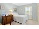 Cozy bedroom with a single bed, wooden desk, and soft natural light from the window at 1035 Aquilla Rd, Benson, NC 27524