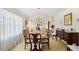 Elegant dining room featuring a chandelier, large table with seating, and natural light from sheer curtains at 1035 Aquilla Rd, Benson, NC 27524