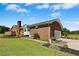 A brick home with manicured landscaping, an attached garage, and a quaint walkway at 1035 Aquilla Rd, Benson, NC 27524