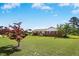 A ranch-style home with a brick facade, large front yard, mature trees, and well-maintained landscaping at 1035 Aquilla Rd, Benson, NC 27524