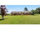 Lovely single-story brick home with a large front yard and mature trees at 1035 Aquilla Rd, Benson, NC 27524