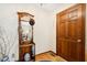 Welcoming foyer featuring a wooden door, mirror, hardwood floors, and patterned wallpaper at 1035 Aquilla Rd, Benson, NC 27524