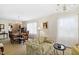 Traditional living room with chandelier, formal dining area, and floral sofa at 1035 Aquilla Rd, Benson, NC 27524