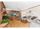Spacious living room with hardwood floors, built-in shelves, and a brick fireplace at 1035 Aquilla Rd, Benson, NC 27524