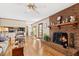 Living room with fireplace, ceiling fan, and view to the kitchen at 1035 Aquilla Rd, Benson, NC 27524