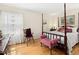 Bedroom featuring a four-poster bed and hardwood floors at 1035 Aquilla Rd, Benson, NC 27524